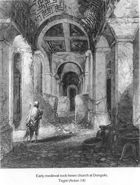 An interior view of an ancient rock-hewn church with a figure holding a cross in the foreground.