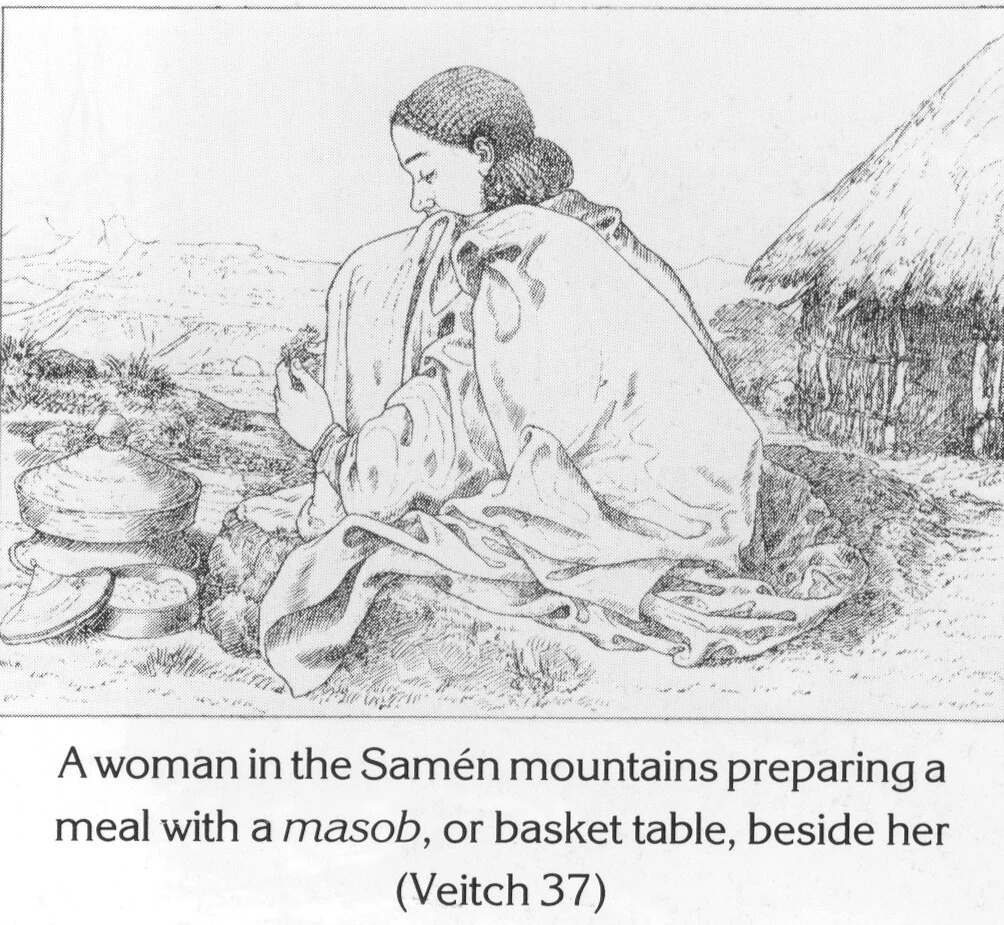 A woman in the Samén mountains preparing a meal with a masob, or basket table, beside her (Veitch 37)