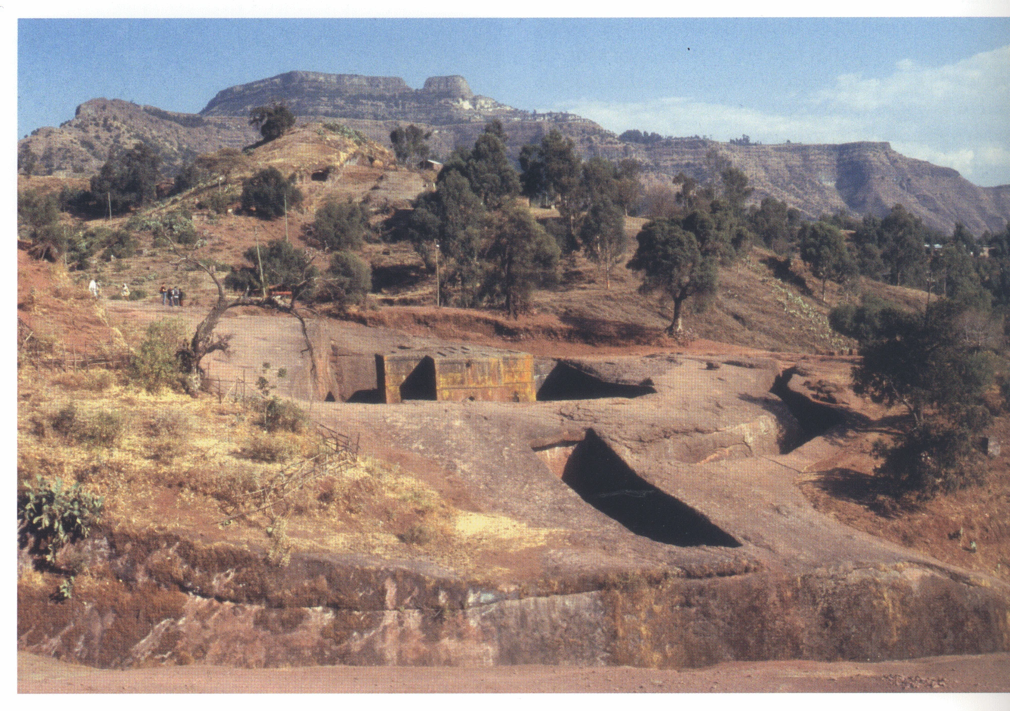 229 Beta Giyorgis, general view from the west, 2006. In the foreground is the canalised course of the Giyorgis torrent, with the old approach behind. The peaks of Asheten are on the horizon, directly behind the church.