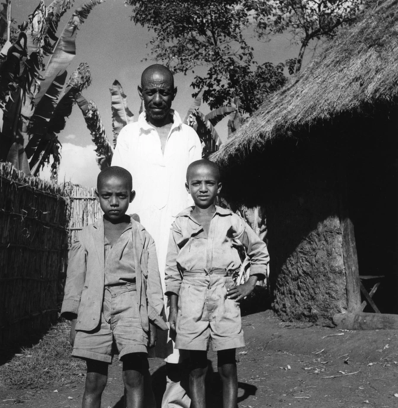 Father and Sons in Yard of Homestead