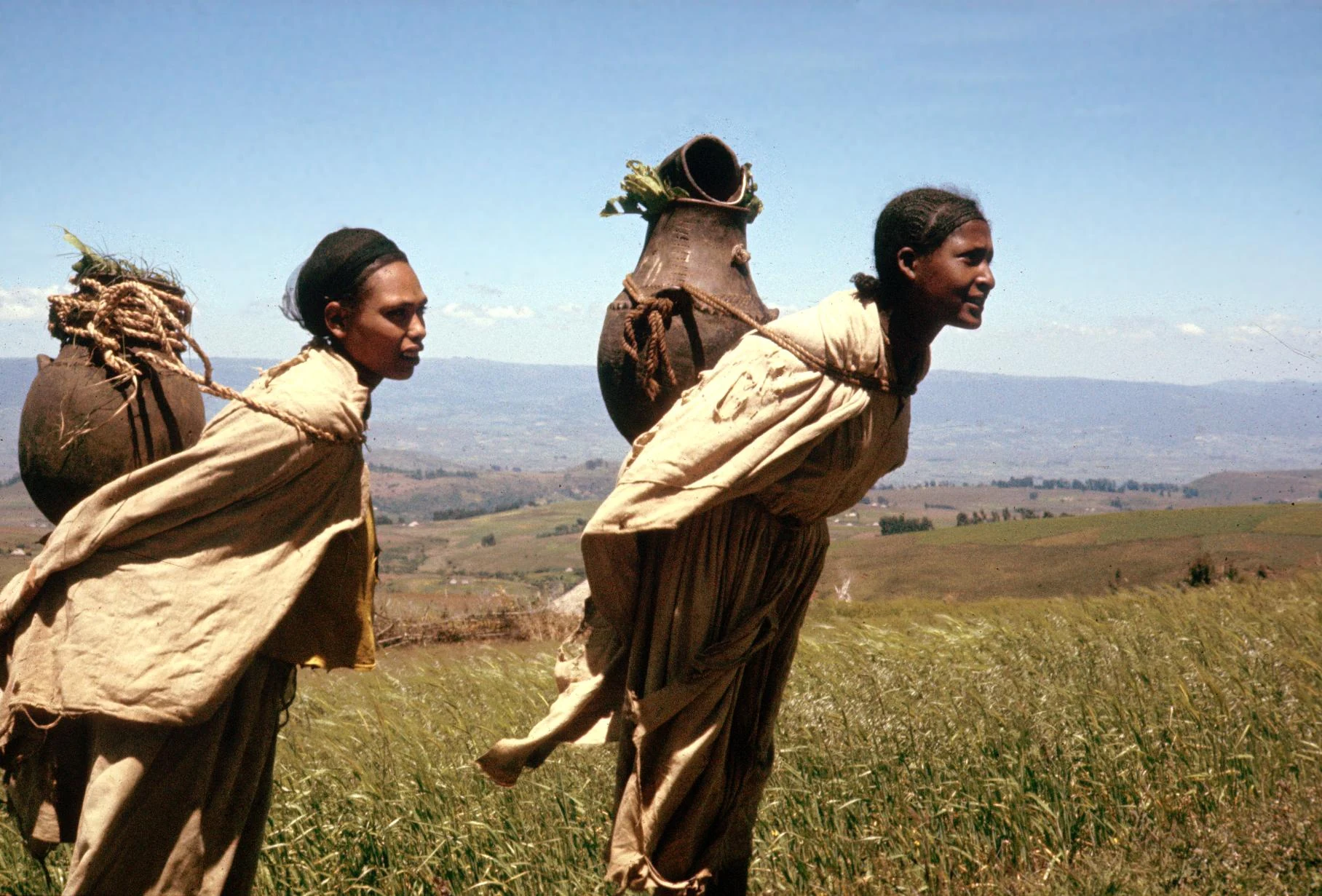 Oromo Women Carrying Loads in Ceramic Vessels