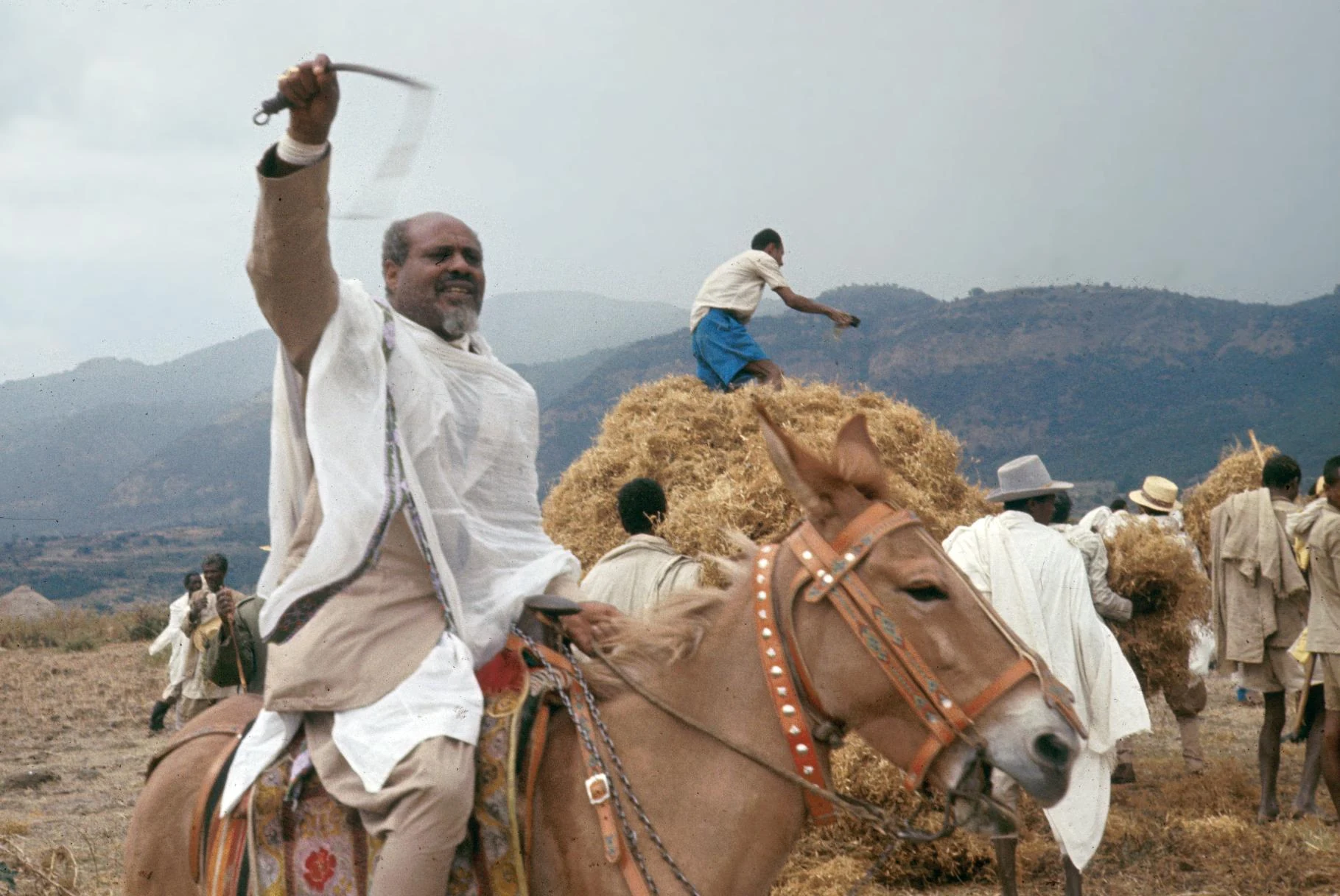 Spirit Medium (K'allu) Overseeing Stacking of Grain