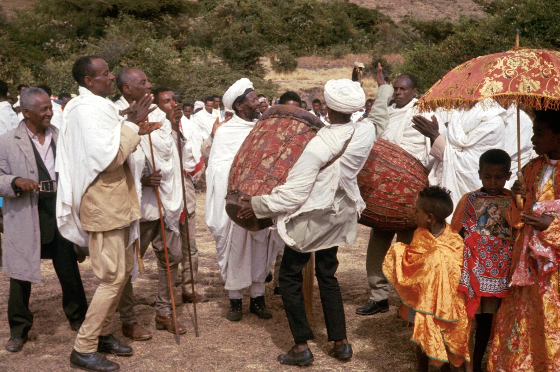 Followers Carrying Drums and Leaning Sticks