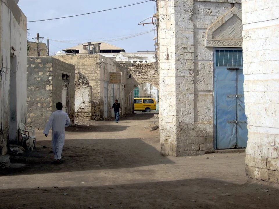Old Massawa: coral-block masonry beside a narrow street.