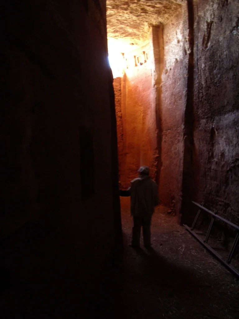 Maryam Debra Tsion: narrow internal rock-cut corridor showing a spatial condition distinct from the exterior.
